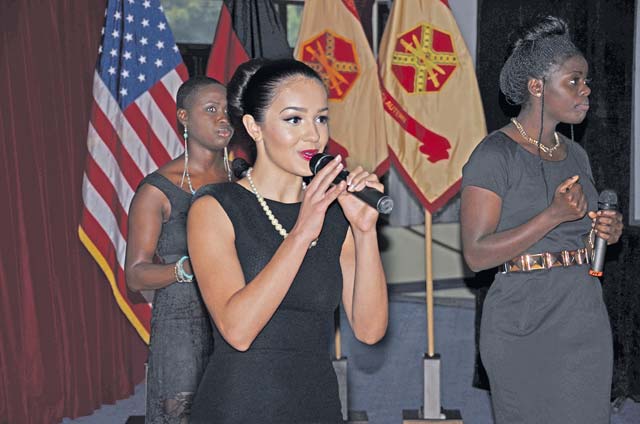 Photo by Dijon Rolle Claudia Nallely Agres, a member of the female singing group Shining Diamonds, performs for the audience during the garrison’s annual Women’s Equality Day luncheon Monday.