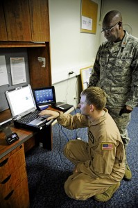 Tech. Sgt. Jonathan Andrew, 375th Aeromedical Evacuation Squadron flight instructor, goes over the electronic health record system and “my Wi-Fi” with Maj. Justice Sakyi, Air Mobility Command division chief, July 19 on  Ramstein.