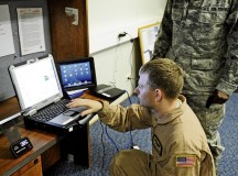 Tech. Sgt. Jonathan Andrew, 375th Aeromedical Evacuation Squadron flight instructor, goes over the electronic health record system and “my Wi-Fi” with Maj. Justice Sakyi, Air Mobility Command division chief, July 19 on  Ramstein.