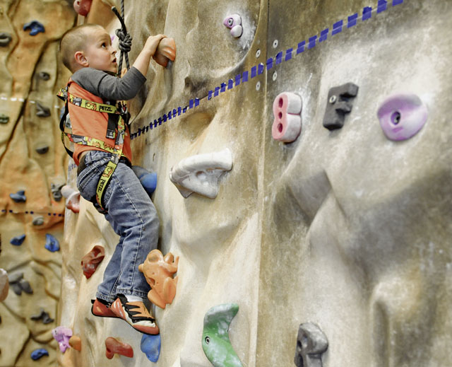 Photo by Airman 1st Class Holly MansfieldIsaac Siembida, son of Master Sgt. Jeremiah Siembida, U.S. Air Forces in Europe and Air Forces Africa command programs manager, climbs the rock wall at the Outdoor Recreation Center during an Exceptional Family Member Program event in May on Ramstein. EFMP offers medical and force support to military families with special needs.