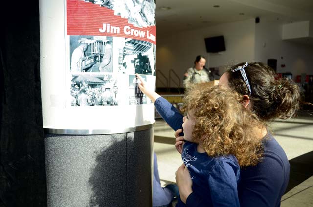 Photo by Dijon RolleLiliana Taboas and her mother Lucero Hernandez get a closer look at an African-American history poster during the Black History Month Extravaganza Feb. 20. Members of the garrison’s Equal Opportunity Working Group hosted the event at the Kaiserslautern Military Community Center food court. The poster was just one of several items on display during the community event, which also featured dancing, singing and musical performances.