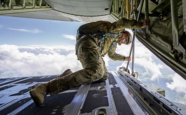 U.S. Army 1st Sgt. Leldon Lee Want, Special Operations Command Europe Joint Special Operations Air Component senior enlisted leader, looks out the back ramp of a U.S. Air Force C-130J Super Hercules to ensure Romanian paratroopers can safely exit the aircraft during Carpathian Spring 2014 May 18 above Campia Turzii, Romania. Jumpmasters from Ramstein and Royal Air Force Mildenhall, England, took part in the training to help guarantee jumps went smoothly.