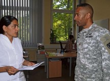 Maj. Edward Brown, 21st Theater Sustainment Command, speaks with Naini Robinson, Kaiserslautern Soldier For Life Transition Assistance Program counselor, during a visit to the Kaiserslautern Soldier For Life Transition Assistance Program Center July 14.