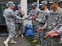 Photo by Pfc. Kelsey M. LittleLt. Gen. Donald M. Campbell Jr. (left), commanding general of U.S. Army Europe, presents a USAREUR challenge coin to Spc. Joshua Middleton, corrections specialist with the 18th Military Police Brigade, 21st Theater Sustainment Command, during his visit to Sembach Kaserne Oct. 9. Middleton was recognized for serving over 200 community service hours.