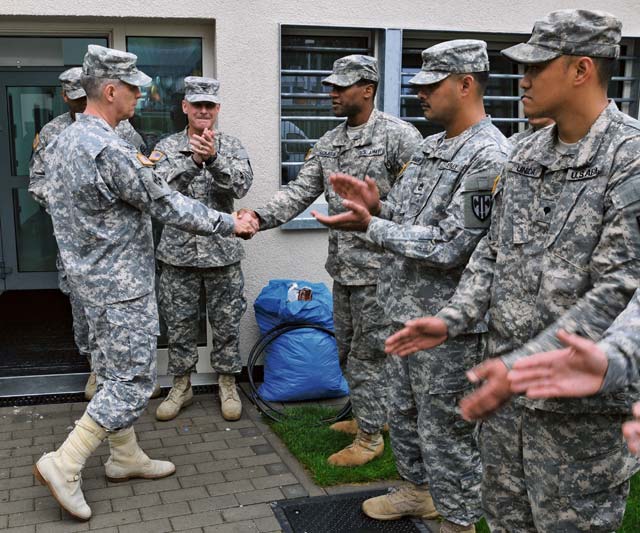 Photo by Pfc. Kelsey M. LittleLt. Gen. Donald M. Campbell Jr. (left), commanding general of U.S. Army Europe, presents a USAREUR challenge coin to Spc. Joshua Middleton, corrections specialist with the 18th Military Police Brigade, 21st Theater Sustainment Command, during his visit to Sembach Kaserne Oct. 9. Middleton was recognized for serving over 200 community service hours.
