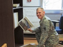 Sgt. 1st Class John Hickman, 409th Contracting Support Brigade, unpacks files in the new 409th CSB headquarters location in Sembach.