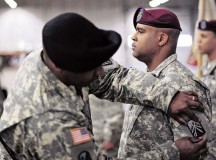 Command Sgt. Maj. Jessie C. Harris Jr., 21st Theater Sustainment Command’s 39th Transportation Battalion, 16th Sustainment Brigade senior enlisted adviser, places the 16th Sust. Bde. patch on the shoulder of 1st Sgt. Gene L. Saunders, 5th Quartermaster Company (Rigger), 39th Trans. Bn. first sergeant, during a transfer of authority ceremony Jan. 6 on Rhine Ordnance Barracks.