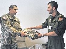 U.S. Army Spc. Fausto F. Jimenez (left), a human resources specialist assigned to the 16th Sustainment Brigade headquarters, hands Macedonian Maj. Dragam Pavlovski, a member of the Macedonian Air Force Brigade, his laundry during Operation Immediate Response 13 at Petar Zrinski Barracks Aug. 28.
