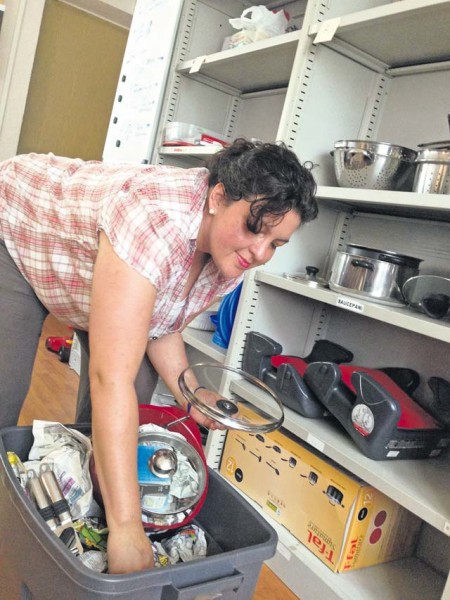 Courtesy photo Monica Wyatt, a relocation assistant with the Army Community Service office in Kaiserslautern, sorts through items designated for customer use from the Lending Closet on Pulaski Barracks. Newcomers can borrow common household items until their shipped goods arrive, and the program is one of the more utilized services of the ACS.