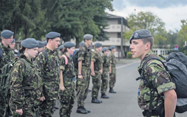 British Air Training Corps Detachment Warrant Officer Mathew Craigs, 224th ATC, calls a group of more than 40 British cadets to attention Aug. 14 in front of the Kisling Noncommissioned Officer Academy on Kapaun. The cadets from England, Wales and Northern Ireland took part in the event that immersed them into the life of a U.S. Air Force NCO attending the Kisling NCOA.