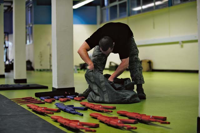 Staff Sgt. Joshua R. Marugg, 435th Security Forces Squadron F.A.S.T. NCOIC, prepares training weapons for instructing the weapons retention and take-away portion of a F.A.S.T. course. During the course, Airmen have the opportunity to learn how to deal with a variety of weapons hostiles may be equipped with. 