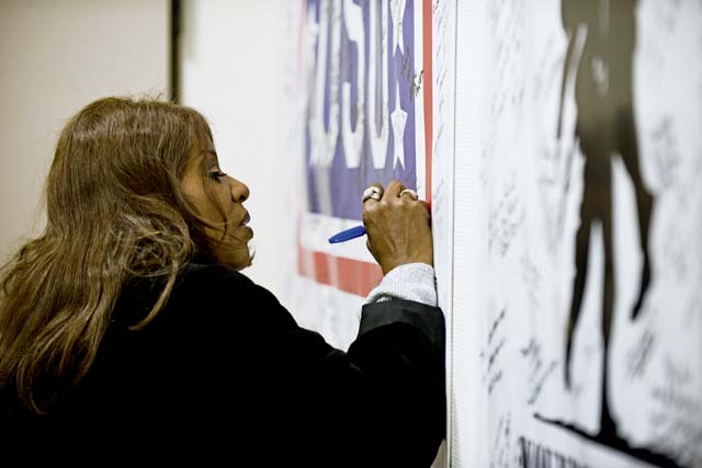 Photo by Senior Airman Jonathan StefankoGloria Gaynor, “I Will Survive” singer, signs a USO poster at the Contingency Aeromedical Staging Facility on Ramstein during a tour Dec. 26. Gaynor interacted with the CASF staff and patients during her visit and spoke about resiliency, survival and empowerment. 