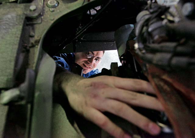 Airman 1st Class Lorne Abshire, 86th Vehicle Readiness Squadron light vehicle mechanic, checks the transmission of a Humvee.