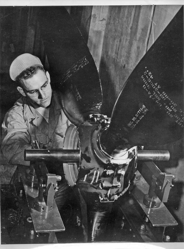 A B-17 crew member balances a propeller in order to make repairs during World War II. Some B-17s were assigned to U.S. Air Forces in Europe in the late 1940s and were used as reconnaissance planes, renamed RB-17 Flying Fortresses. 