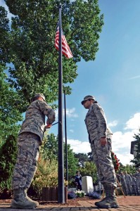 Photo by Senior Airman Aaron-Forrest WainwrightStaff Sgt. Robert Webber, 603rd Air Communications Squadron quality assurance provider, and Senior Airman Chardonnay Taylor, 1st ACOS administrator, lower the  U.S. flag during the wreath laying ceremony as a part of POW/MIA week Sept. 21 on Ramstein.