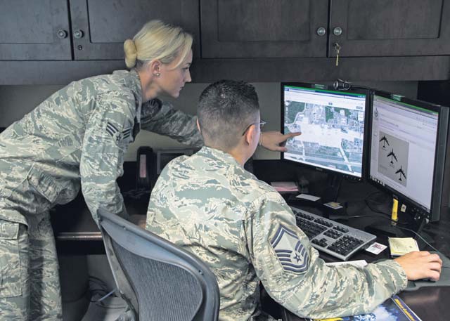 Courtesy photo Senior Airman Shabree Heasell and Senior Master Sgt. Ryan Thuyns, both U.S.  Air Forces in Europe and Air Forces Africa imagery analysts, look at images on a computer July 29 on Ramstein Air Base, Germany. Heasell was recently named one of the 12 Outstanding Airmen of the Year. As an imagery analyst, Heasell developed primary and alternate secret service routes, which secured the visits of not only President Obama but also 223 other personnel.