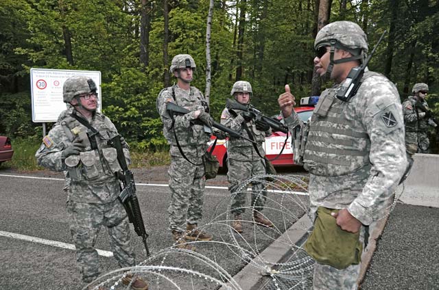 Sgt. Quinton Fisher (right) discusses perimeter security during Warrior Response.