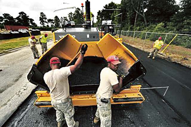 Photo by Senior Airman Kenneth Holston Senior Airman Ahl Raym Tolrio and Senior Airman Malcolm Stone, both assigned to the 823rd RED HORSE Squadron, sift asphalt as it is being laid July 12, 2012, on Aiken Street on Shaw Air Force Base, S.C. The 823rd RHS is an Air Combat Command asset assigned to the Ninth Air Force that operates out of Hurlburt Field, Fla. RED HORSE stands for Rapid Engineer Deployable Heavy Operational Repair Squadron Engineer.