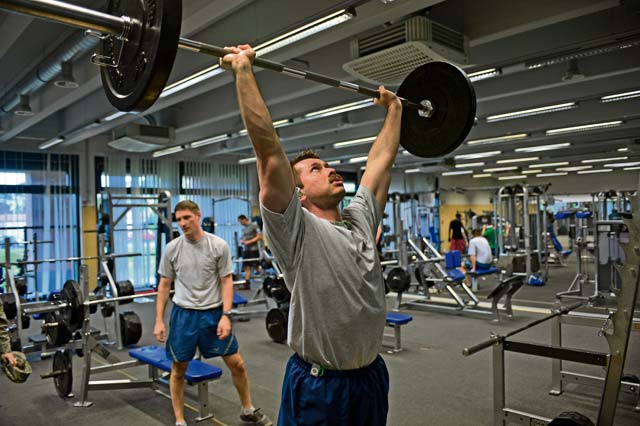 Photo by Airman 1st Class Jordan Castelan Improving fitness Capt. James Burke, 37th Airlift Squadron chief of training and scheduling, lifts weights May 9 at the Ramstein Southside Fitness Center. Burke frequents the gym to improve his overall fitness.