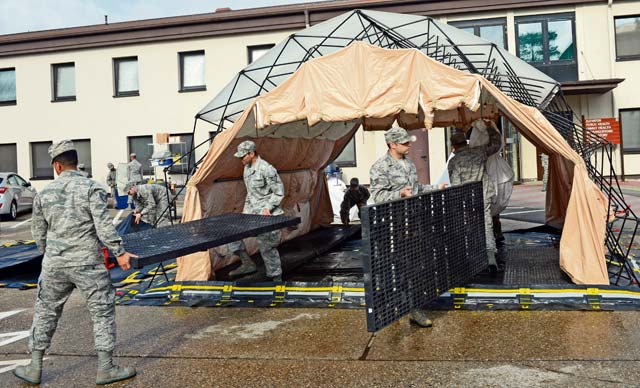Photo by Senior Airman Caitlin O’Neil-McKeown Medical group training Members of the 86th Medical Group build a decontamination tent at the medical clinic during monthly training May 10 on Ramstein. During the training, medical Airmen learned to respond to a variety of scenarios and emergency procedures.