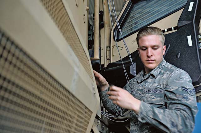 Photo by Senior Airman Aaron-Forrest Wainwright Vehicle maintenance Airman 1st Class Lawrence Aiello, 86th Vehicle Readiness Squadron maintainer, repairs the fire suppression system on a Mine-Resistant Ambush Protected vehicle, May 23 on Ramstein. The mechanics help maintain the largest vehicle fleet in the Air Force; approximately 5,000 work orders per year.  