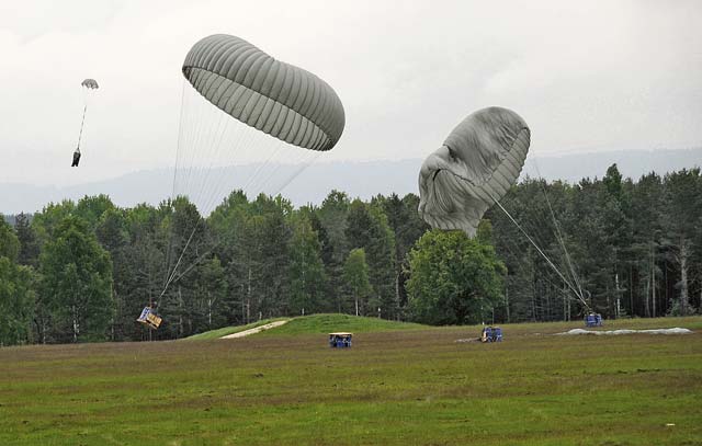 Photo by Staff Sgt. Warren W. Wright Jr.  16th SB practice aerial resupply ops in Grafenwoehr Pallets containing more than 4,000 pounds of water are air dropped onto the Bunker Drop Zone at Grafenwoehr, during an aerial supply delivery, May 23.  Soldiers with the 21st Theater Sustainment Command’s 5th Quartermaster Detachment and 16th Sustainment Brigade joined together to conduct the aerial supply training in order to be better prepared in conducting real-world operations in a forward area.  