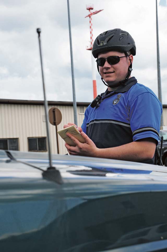 Photo by Airman 1st Class Hailey Haux Bike patrol  Senior Airman Dave Hirschmann, 86th Security Forces Squadron installation patrolman, issues a ticket May 24 on Ramstein. The bike patrols’ main priority is to ensure the safety of the community on base.  