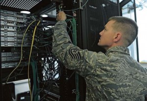 Photo by Senior Airman Caitlin Guinazu Tech. Sgt. Bradley Johnson, 1st Communications Maintenance Squadron special communication team leader, inspects communication equipment, May 24 on Kapaun.  Johnson has been recognized by the 435th Air Ground Operations Wing as the most recent Thunderbolt Award recipient.