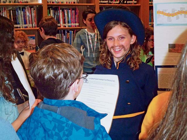  Kaitlyn Booth, playing the role of Gen. George Armstrong Custer, presents information about the life and times of the famous military figure to student visitors at the Living Wax Museum.