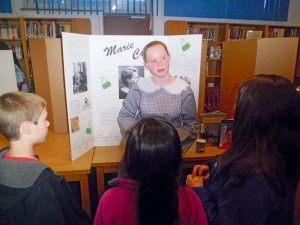 Madame Marie Curie (played by Addison Borchelt), famous for her research in radioactivity, tells visitors about her life and work as a scientist.