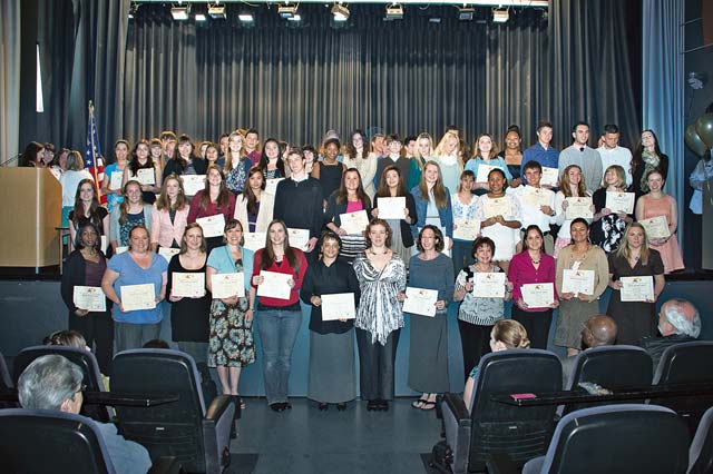 Photo by Nichole Gonzalez Scholarship recipients pose for a photo recently after a scholarship ceremony was held at the Galaxy Theater on Ramstein.