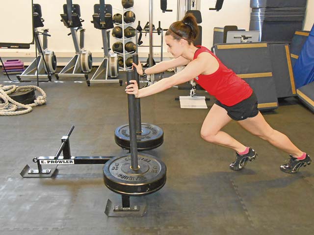 Photo by Cesar Alvarez Sarah Clum, Ramstein Health and Wellness Center health and fitness specialist, performs sled training as high intensity interval training.