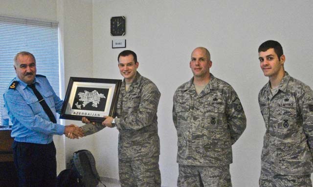 Courtesy photo Capt. Matthew Tempia, 435th Contingency Response Group air adviser and executive officer, receives a token of appreciation from the Azeri military April 16 in Baku, Azerbaijan. Tempia led a three-man team to conduct an air base defense and security forces familiarization event to build partnerships and improve mission capabilities with NATO allies.