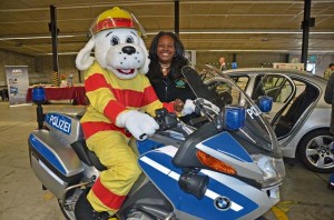 Crystal Malloy, Employee Assistance Program, poses with Sparky the Fire Dog.
