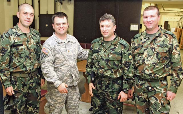 Maj. James Joubert, a physician with the 196th Medical Support Unit of the 21st Theater Sustainment  Command’s 7th Civil Support Command, poses with (from left) Bulgarian army Sgt. Peter Evgeniev Dzhongov, Bulgarian army Lt. Col. Georgi M. Malinov and Bulgarian army Sgt. Tsvetan I. Petrov during a training event May 17.