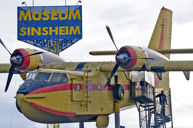 RIGHT PHOTO: A Canadair firefighting plane sits atop Hall 1 at the Auto & Technic Museum Sinsheim. Visitors can explore the inside of the plane, which was brought to the museum in 2005.