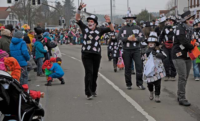 Parade participants pass out treats and interact with the crowd during the Fasching parade.