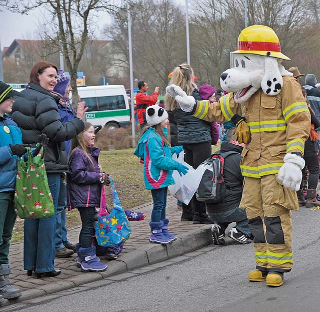 Sparky the Fire Dog waves to the crowd during the Fasching parade Tuesday in Ramstein-Miesenbach.