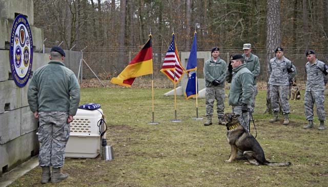 Staff Sgt. Bradley Beaty, 86th Security Forces Squadron K-9 handler, and Omega, a military working dog, pay their respects Feb. 24 to Sano, an MWD who was recently put to rest. The 86th SFS held a memorial ceremony to honor Sano’s eight years of service to the Air Force. 