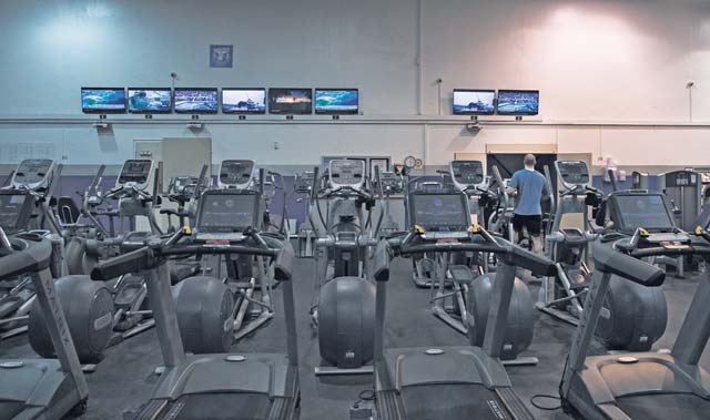A fan watches Super Bowl XLIX while working out Feb. 1 at the Ramstein Northside Fitness Center.