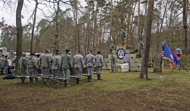 Memorial service attendees stand in honor of Sano, 86th Security Forces Squadron military working dog, who was put to rest Feb. 24 on Ramstein.