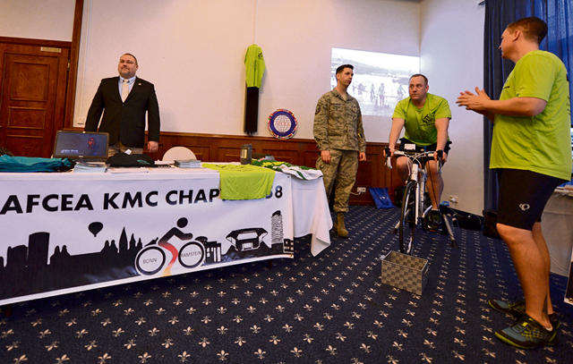 Master Sgt. Etienne Tousignant (center right), Ramstein career assistance adviser, rides a stationary bicycle to raise funds for the Armed Forces Communication and Electronics Association.