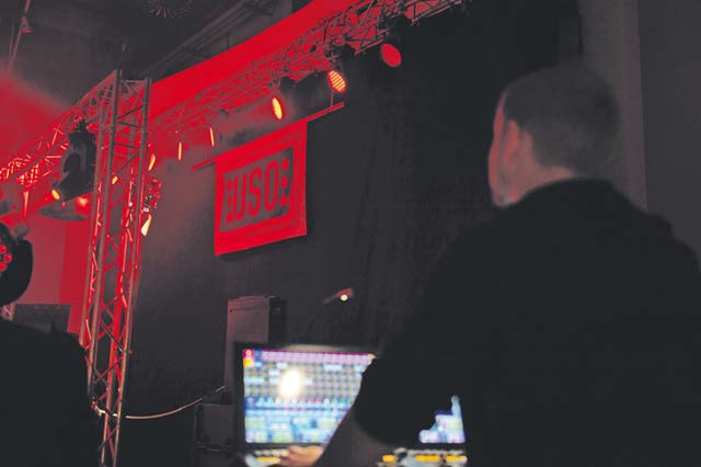 A technician for the USO Electronic Dance Music tour manages the light display as a disc jockey plays for service members on Ramstein.