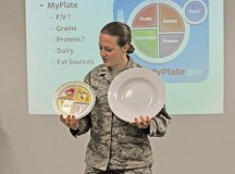First Lt. Lindsey Leitz, Health Promotion nutrition program manager, demonstrates the difference between a nine-inch plate, which would provide proper proportions when eating, to the 12-inch plates served at many restaurants during the Healthy Living Class Feb. 9 on Ramstein.