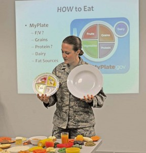 First Lt. Lindsey Leitz, Health Promotion nutrition program manager, demonstrates the difference between a nine-inch plate, which would provide proper proportions when eating, to the 12-inch plates served at many restaurants during the Healthy Living Class Feb. 9 on Ramstein.