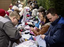Maj. Matthew Boyd (right), 86th Airlift Wing chaplain, arranges donated clothing for the less fortunate in the local community Feb. 21 in Kaiserslautern. Boyd continues his long lineage of serving in the military as a chaplain offering guidance and contentment for those in need.