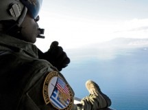 Photo by Senior Airman Nicholas CrispSenior Airman Ralph Colas, 37th Airlift Squadron loadmaster, looks out the back of a C-130J Super Hercules Feb. 3 as it flies over the Greek landscape during Stolen Cerberus II, a flying training deployment in Elefsis, Greece. The FTD is designed to gauge both aircraft and personnel capabilities as well as improve the interoperability of the Airmen and their Greek counterparts.