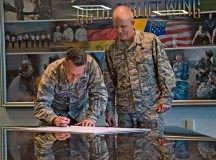 Brig. Gen. Patrick X. Mordente, 86th Airlift Wing commander, signs a Military Saves Week proclamation Feb. 13 on Ramstein as Chief Master Sgt. Frank Batten III, 86th AW command chief, looks on. Military Saves, a component of the nonprofit America Saves and a partner in the Department of Defense’s Financial Readiness Campaign, seeks to motivate, support and encourage military families to save money, reduce debt and build wealth. The proclamation declares Feb. 23 to 27 as Military Saves Week, encouraging service members to set financial goals.