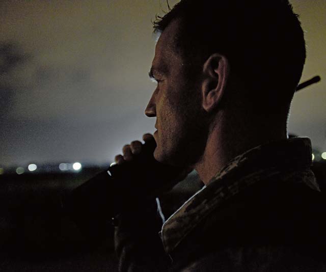 Master Sgt. David Hough, 435th Air Mobility Squadron contingency airfield manager, speaks to the crew of a C-130J Super Hercules as it approaches a runway Feb. 5 in Elefsis, Greece. The 435th Air Ground Operations Wing’s Contingency Response Group is implementing a new landing zone program that will allow members of CRG to prepare landing zone operations, from picking the location to actually providing limited air traffic control.