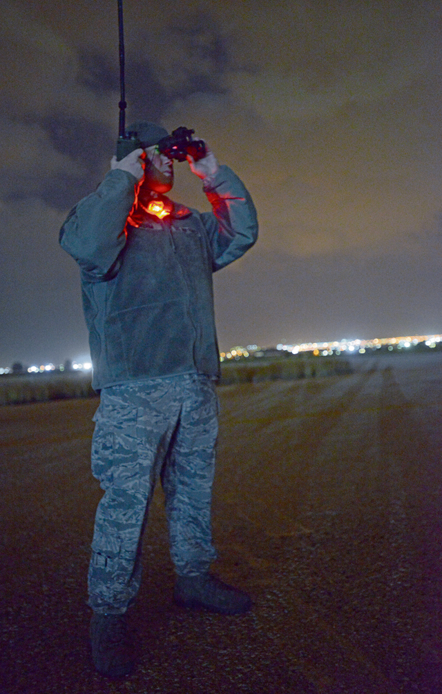 Tech. Sgt. George Broom, 435th Air Mobility Squadron contingency airfield manager, looks through night vision goggles to monitor a C-130J Super Hercules’ approach to a runway Feb. 5 in Elefsis, Greece. The 435th Air Ground Operations Wing’s Contingency Response Group is implementing a new landing zone program that will allow members of CRGs to prepare landing zone operations from picking the location to actually providing limited air traffic control.